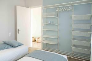 a bedroom with a closet with shelves and a bed at Casa 8 - Two Bedroom House in Patras in Patra