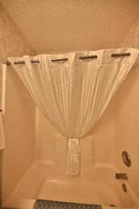 a bath tub with a curtain in a bathroom at Spacious Home by the Beach 2# in Myrtle Beach