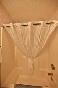 a bath tub with a curtain in a bathroom at Spacious Home by the Beach 2# in Myrtle Beach +27 photos