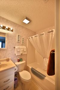 a bathroom with a toilet and a sink and a shower at Spacious Home by the Beach 2# in Myrtle Beach