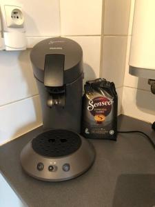 a coffee maker and a box of coffee on a counter at Appartement T1 cosy neuf in Toulon