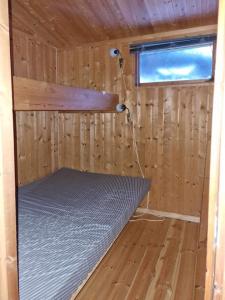a inside of a wooden cabin with a bed in it at Lem Cabins in Sogndal