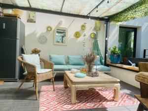 a living room with a couch and a table at Villa Victorine in Nogent-sur-Marne