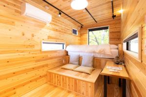 a tiny house with a bed and a desk at CampBaseKadojin - Vacation STAY 73760v in Tenkawa