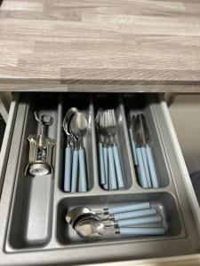 a kitchen sink with utensils in a drawer at Well Equipped Apartment In Stoke on Trent in Stoke on Trent