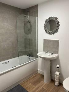 a bathroom with a sink and a shower and a toilet at Well Equipped Apartment In Stoke on Trent in Stoke on Trent