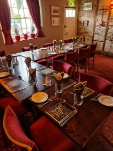 a dining room with tables and chairs and a table and chairs at Kings Arms Hotel in Sandwich