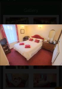 a bedroom with a large bed with red pillows on it at Kings Arms Hotel in Sandwich