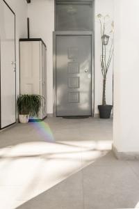 a silver door with a rainbow in front of it at KSP1STUDIO in Perea