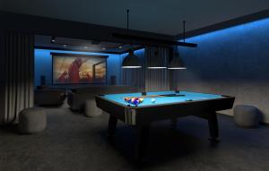 a room with a pool table and a tv at Lazur Seven in Gdańsk +2 photos