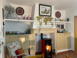 a room with a fireplace with a globe on top of it at Casa Veva Tradición- Siles- in Siles