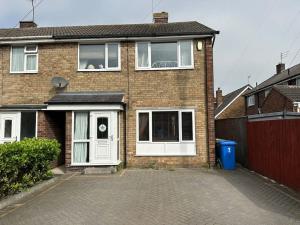 a brick house with white doors and a driveway at Lovely 3 bedrooms house 4 guests in Beverley