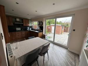 a kitchen and a dining room with a table and a window at Lovely 3 bedrooms house 4 guests in Beverley