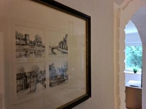 a framed picture of drawings on a wall at Ferienwohnung "Erika" Rees am Niederrhein in Rees