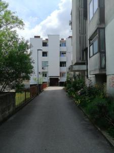 an empty street in a city with tall buildings at Apartman Sanja in Pula