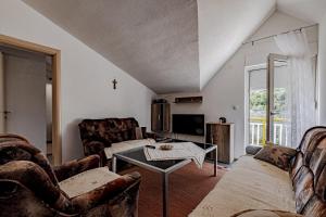 a living room with couches and a table at Apartment Kesten in Janjina