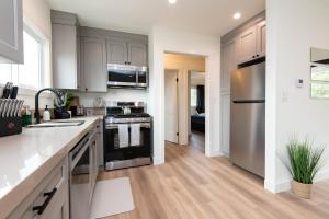 a kitchen with stainless steel appliances and wooden floors at Cozy Apartment in Atwater Village in Glendale