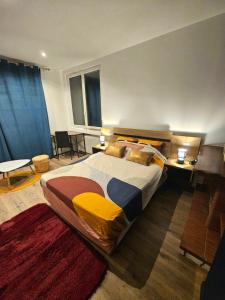 a bedroom with a large bed and two tables at Maison spacieuse jardin Transat - Parking gratuit in Saint-Michel