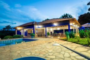 a villa with a swimming pool at night at Hotel Fazenda Tordesilhas in Cocalzinho de Goias