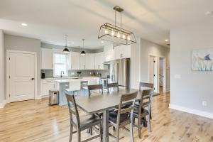 a kitchen and dining room with a table and chairs at Oak Island Fall Getaway Coastal Home and Deck in Oak Island