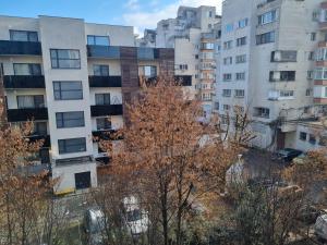 an apartment building with trees in front of it at Nice & Relaxing Central Apartment in Baia Mare