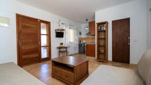 Habitación con cama, mesa y cocina. en Apartaments ES POU en Sant Ferran de Ses Roques