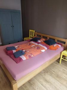 een slaapkamer met een groot bed met een paars matras bij Bulvár apartmán in Žilina