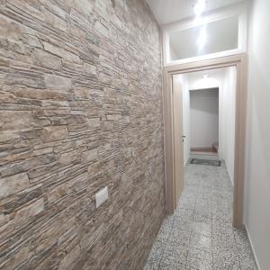 a hallway with a stone wall at Luna Normanna in Rutigliano
