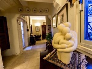 a white sculpture sitting on a table in a living room at Villa Selmunett in Naxxar