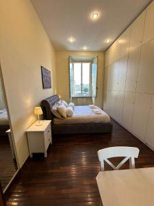 a small bedroom with a bed and a window at NEW Colosseum's Custodian Apartment 115 m2 in Rome