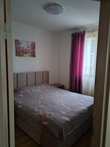 a bedroom with a bed with purple curtains at Magical View in Budva