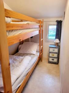 a bedroom with two bunk beds and a window at Gîte VILLA Nautica Résidence Cap Soleil in Vendres