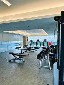 a gym with tables and chairs in a room at Makati Staycation by Marco - SMDC Lush in Manila