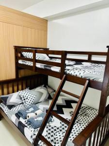 a room with three bunk beds in a room at Makati Staycation by Marco - SMDC Lush in Manila