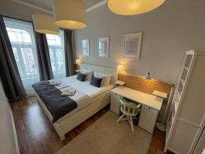 A bed or beds in a room at H75 Apartments Kosice Centre