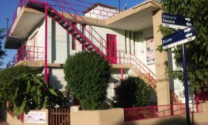 un edificio con una puerta roja y un letrero de la calle en Casa de Fito en Cosquín