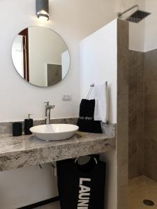 a bathroom with a sink and a mirror at Casa las Margaritas: Beach house in a secluded Pueblo Mágico in Sisal