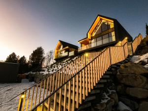 a house on a hill with a wooden fence at RzepiskaView in Rzepiska