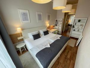 A bed or beds in a room at H75 Apartments Kosice Centre
