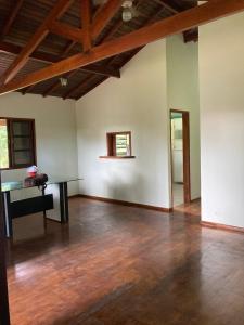 卡拉瓜塔圖巴的住宿－Kerala Guest House Vegan，一间空房间,铺有木地板,设有木制天花板