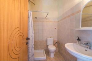 a bathroom with a toilet and a sink at Aleka apartment 2 in Agios Georgios