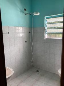 a bathroom with a shower and a sink at Kerala Guest House Vegan in Caraguatatuba