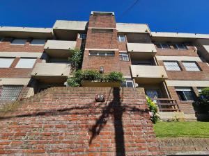 a shadow of a building with a brick wall at 3 Ambientes frente al Golf - Playa Grande in Mar del Plata