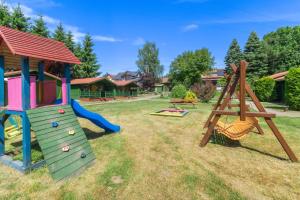 a playground with a slide at Domek 7 osobowy piętrowy in Stegna