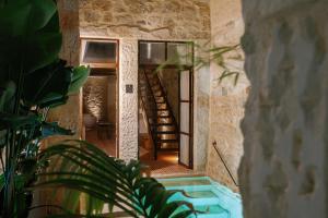 a house with a swimming pool and a spiral staircase at Amalen Suites Adults Only in Rethymno Town