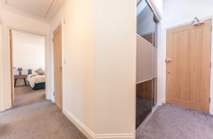 a hallway with a door leading to a bedroom at 2 bed Luton town centre flat in Luton