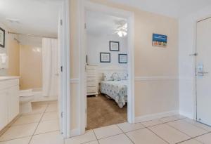 a bedroom with a bed and a shower at Sterling Shores in Destin