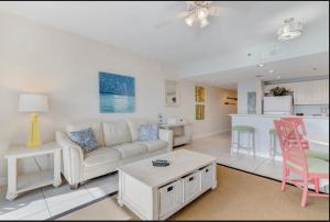 a living room with a couch and a table and a kitchen at Sterling Shores in Destin