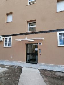 an entrance to a building with a glass door at Il centro di Ostia (apartment) in Lido di Ostia