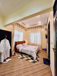 a bedroom with a bed and a window at The Legends Lodge & Apartments in Morogoro